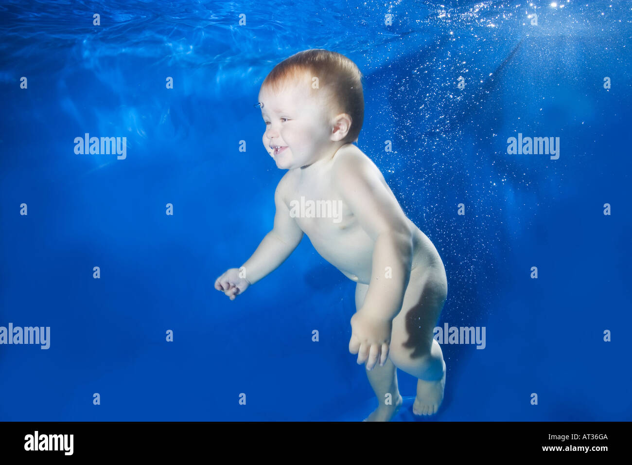 Baby underwater in pool on blue background Stock Photo