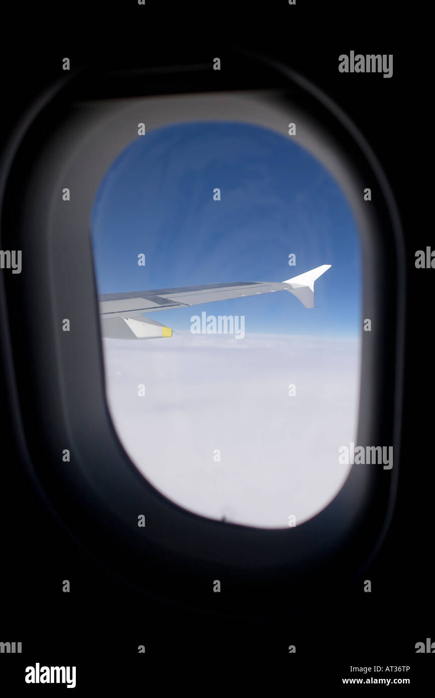 Sitting in a window seat of an Airbus A320 airliner and looking at the right wing and winglet. Stock Photo