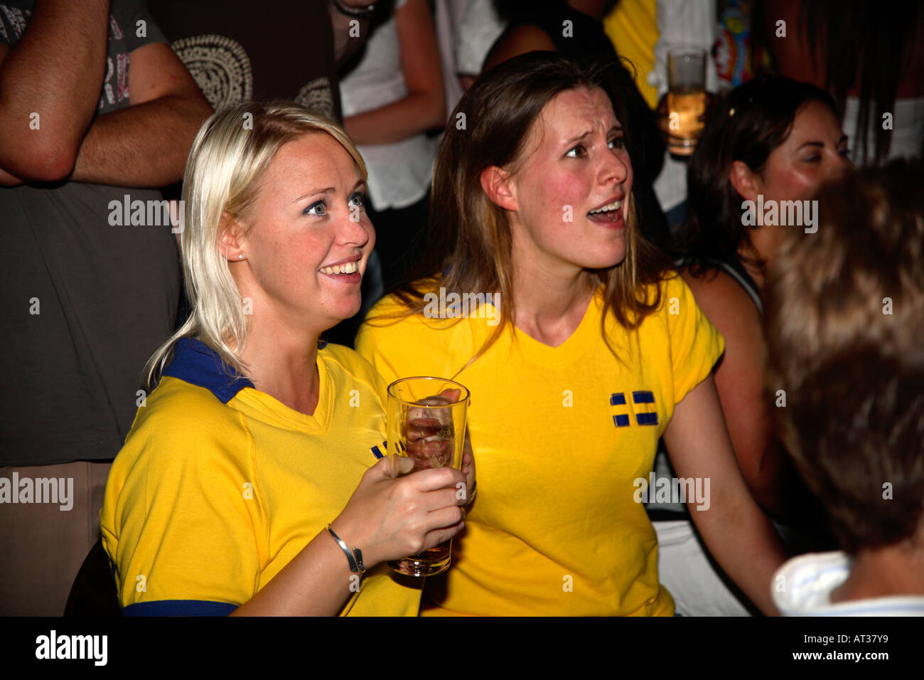 Female Swedish fans watching Sweden's opening game vs Trinidad & Tobago, World Cup 2006, Nordic Bar, London Stock Photo