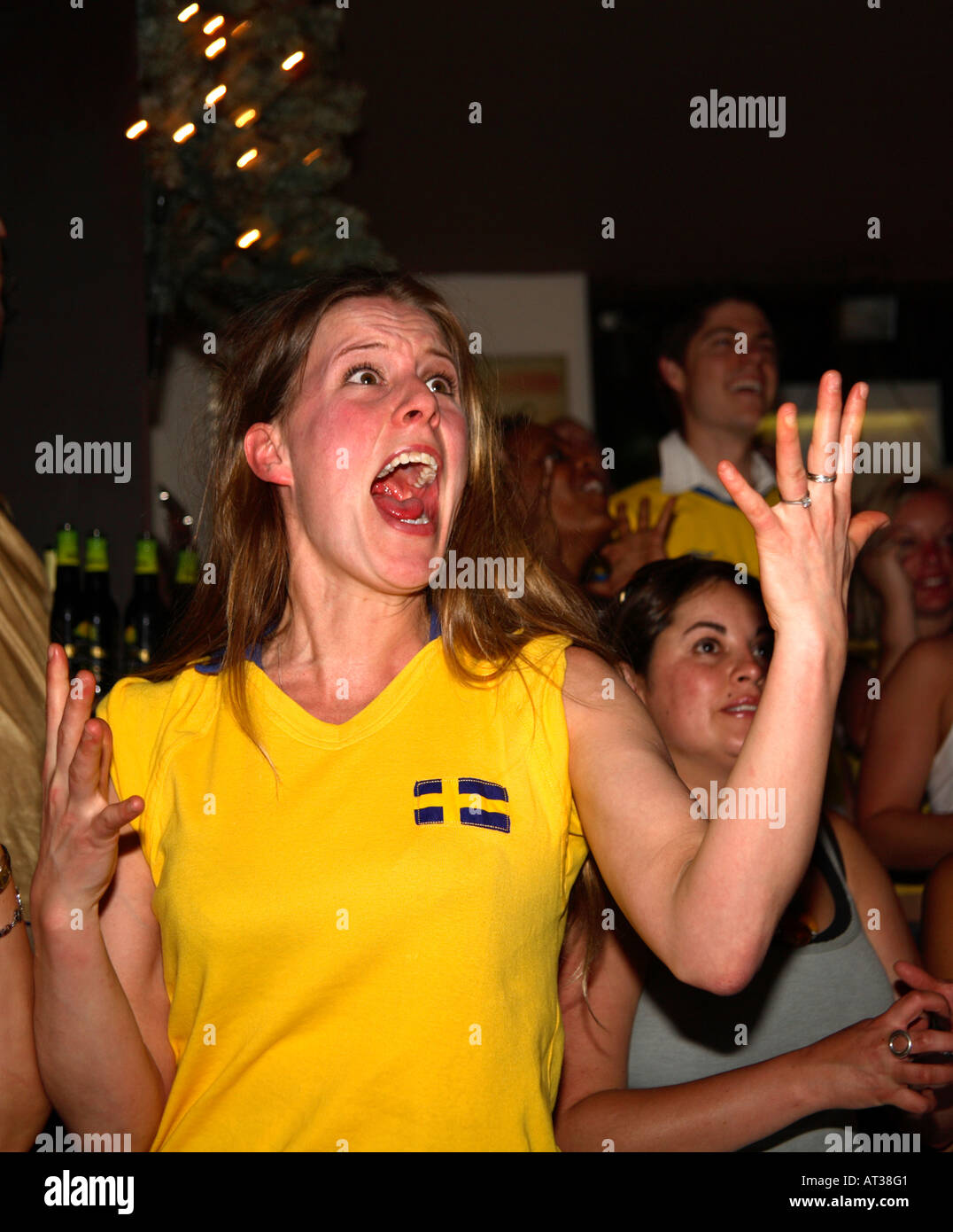 Female Swedish fans watching Sweden's opening game vs Trinidad & Tobago, World Cup 2006, Nordic Bar, London Stock Photo