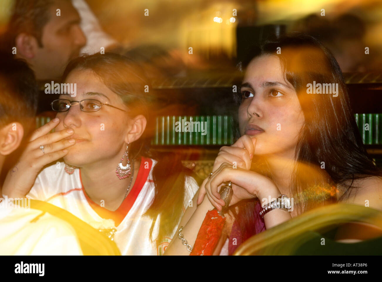 Female Tunisian fans smoking shisha whilst watching their game vs Saudi Arabia, 2006 World Cup, Marimar Restaurant Edgware Rd, Stock Photo