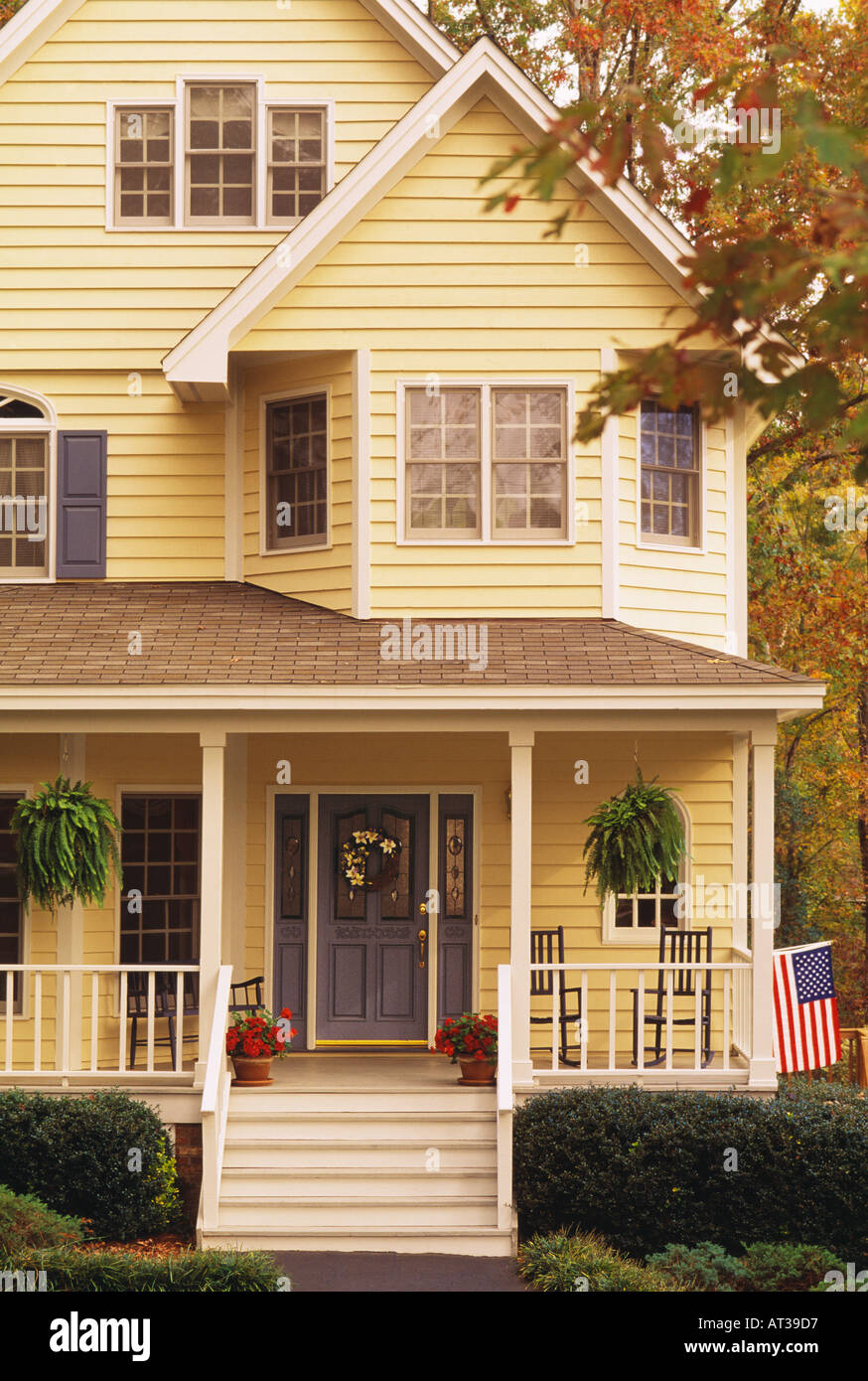 Close up of the front of a two story yellow house Stock Photo - Alamy