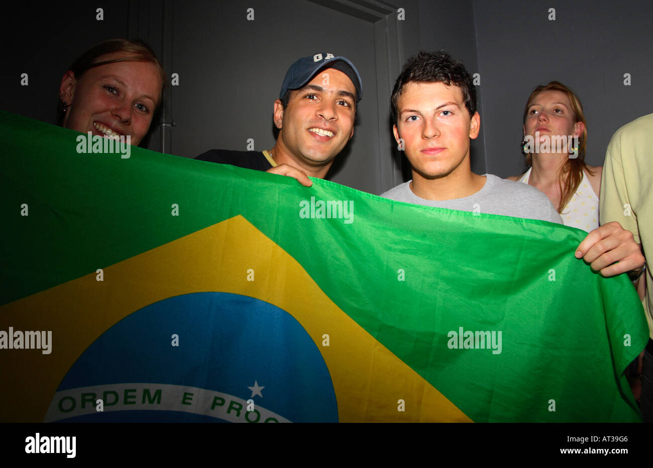Brazilian fans posing with flag during their 2006 World Cup quarter-final vs France, On Anon Bar, London Stock Photo