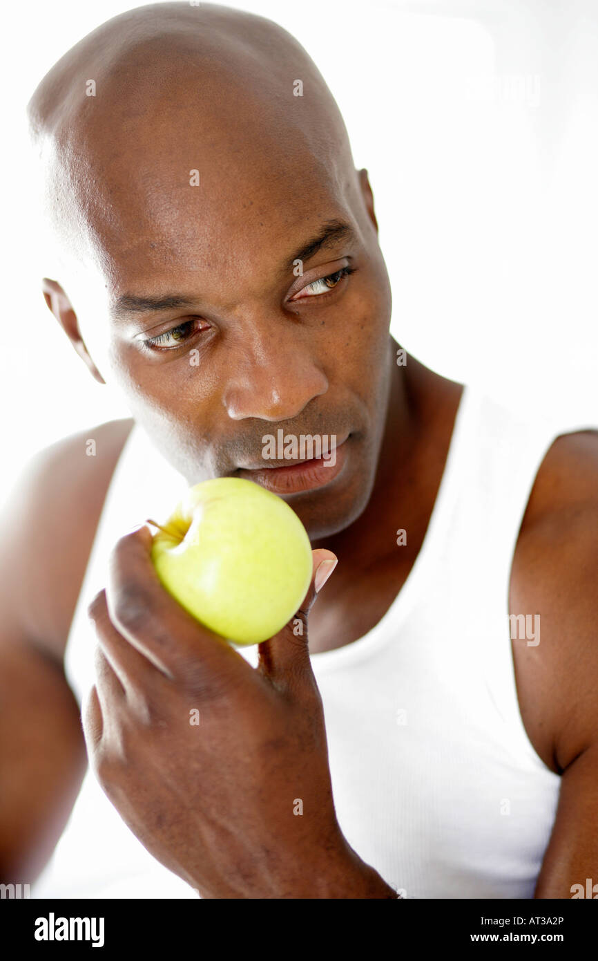A black male eating an apple Stock Photo Alamy