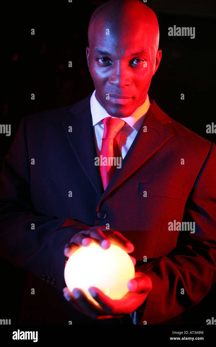 A man holding an oval shaped light between both hands Stock Photo