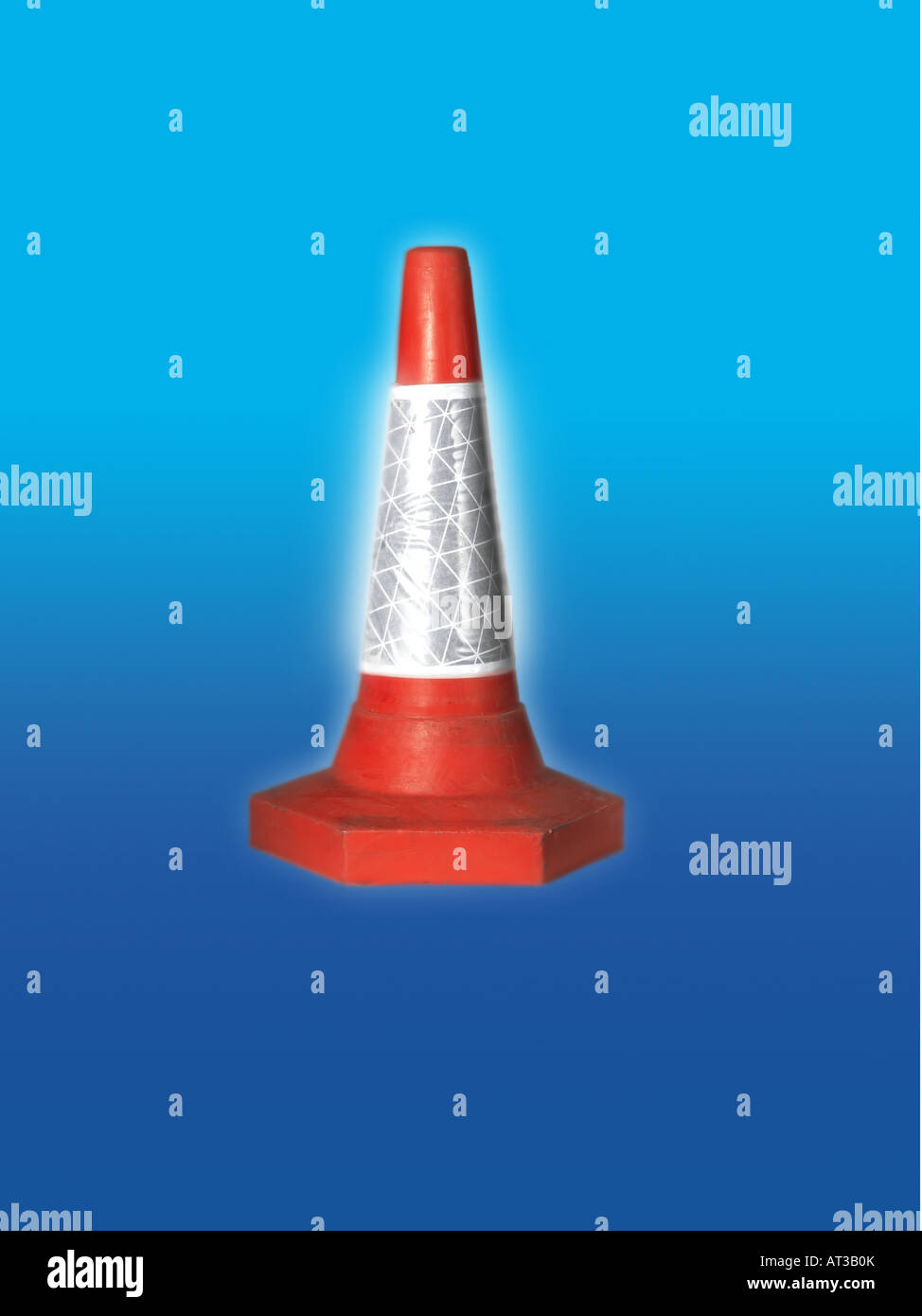 A red traffic cone, blue background Stock Photo