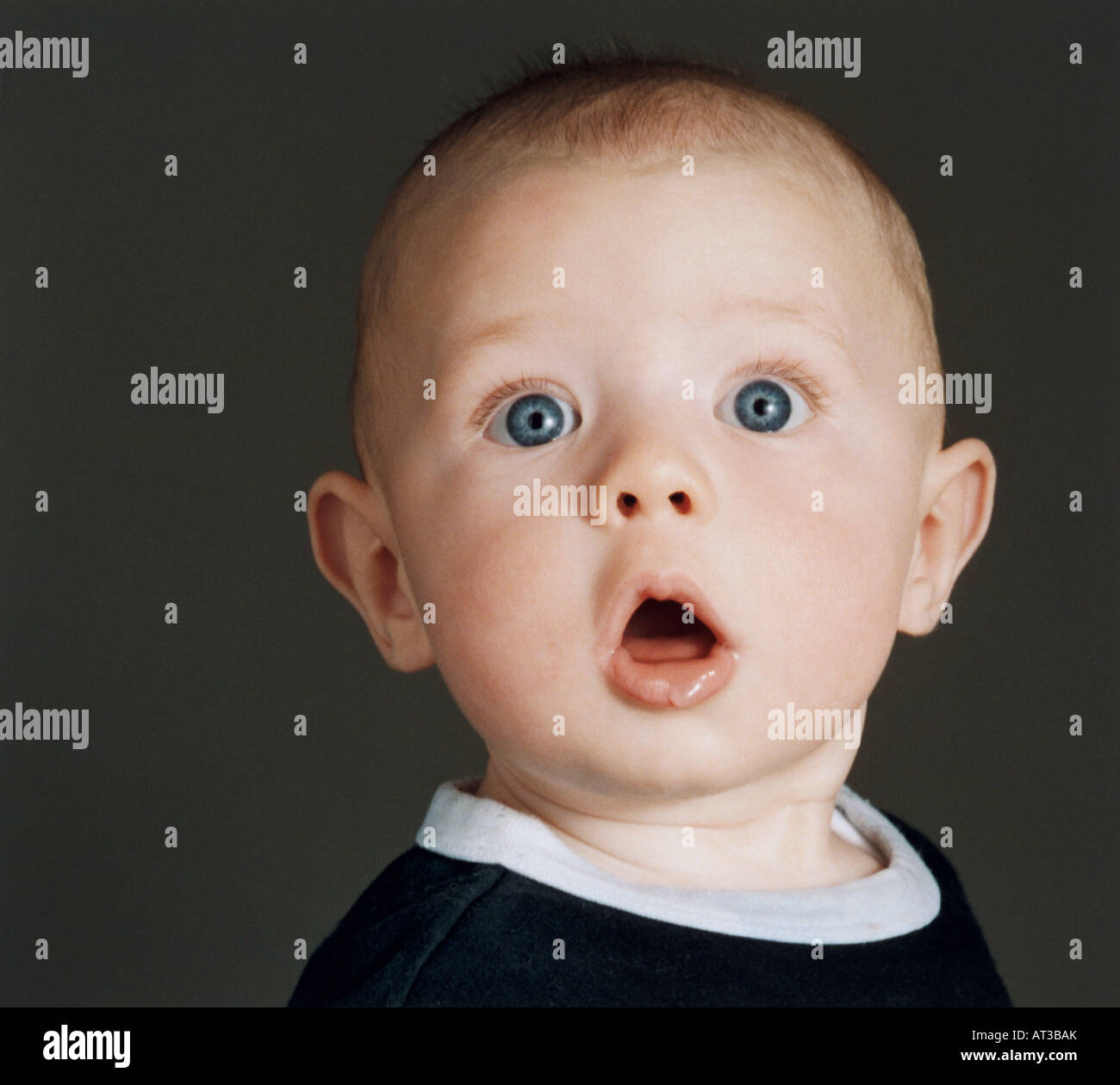 A portrait of a baby looking wide eyed Stock Photo