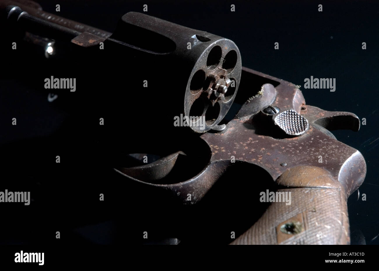 Antique rusted  38 caliber revolver on black reflective background Stock Photo