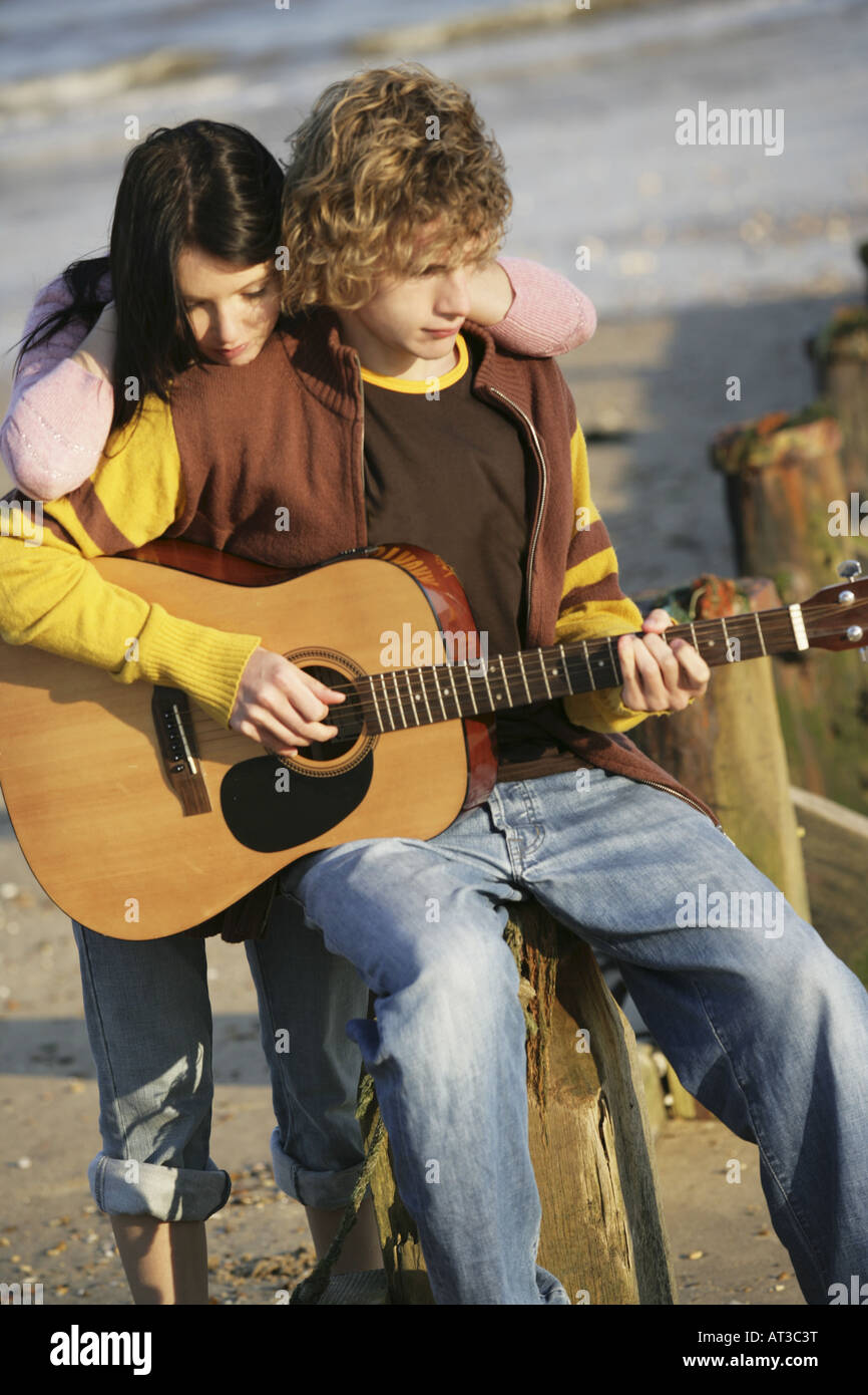 A girl watching her boyfriend play guitar Stock Photo: 16188971 ...