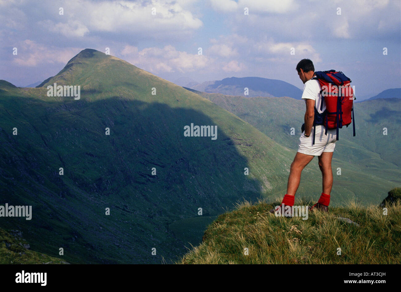 A man standing on top of a mountain Stock Photo - Alamy