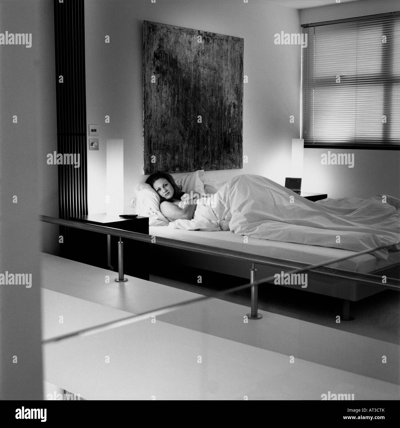 A woman lying in bed Stock Photo