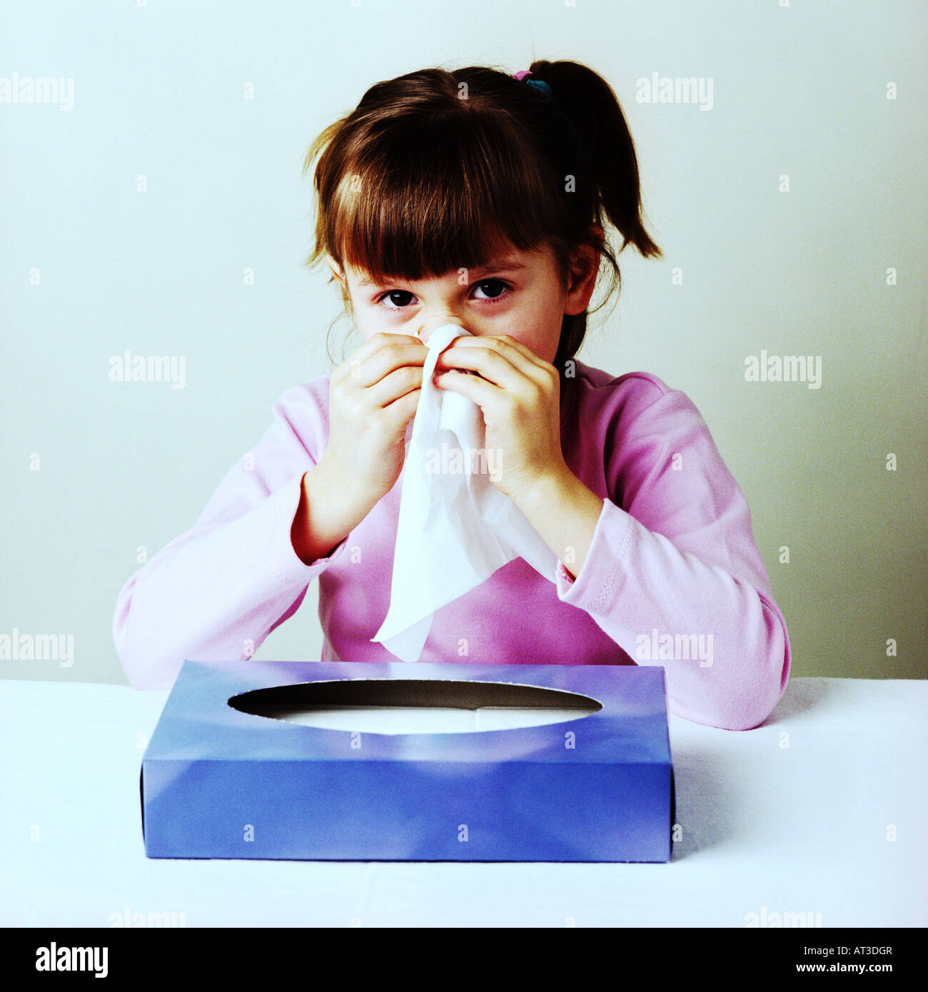 A girl blowing her nose Stock Photo