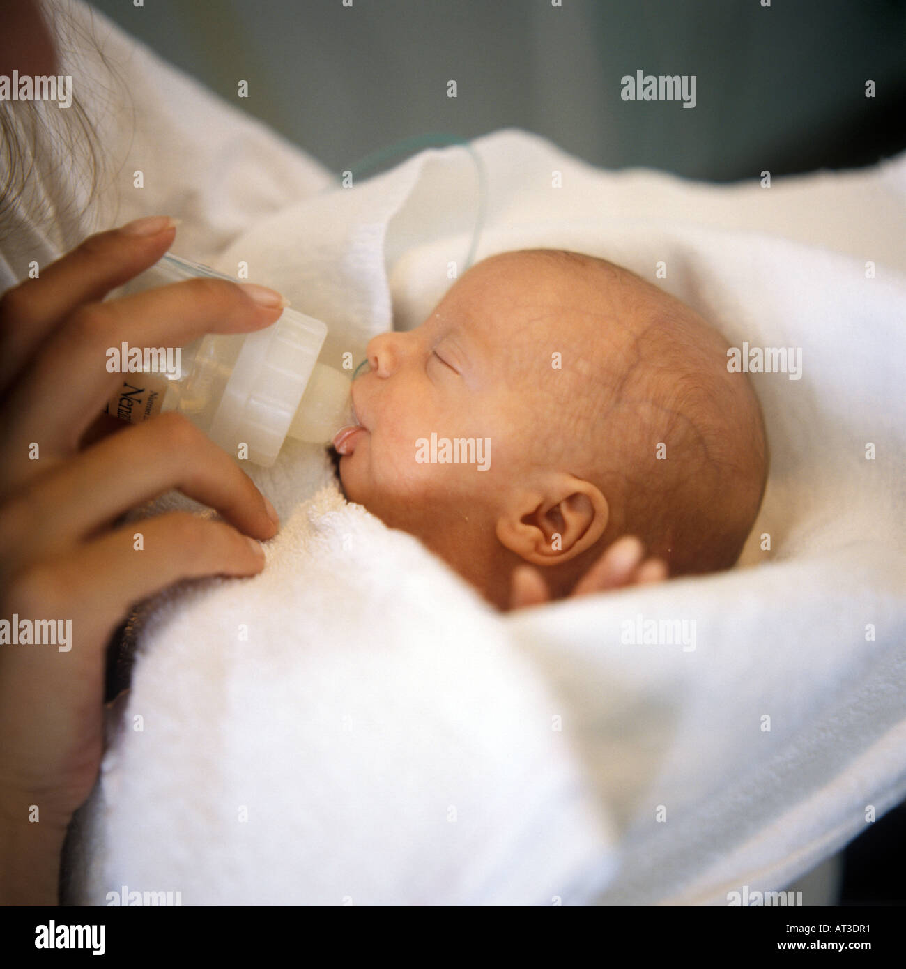 Premature baby gets bottle feeding Stock Photo Alamy