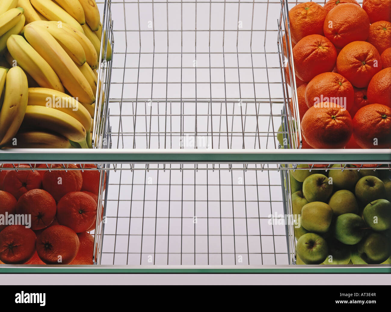 Fruit on display in a shop, with two empty sections Stock Photo