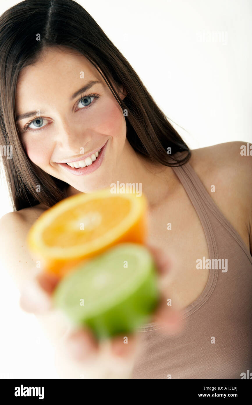 Human hand holding half orange hi-res stock photography and images - Alamy