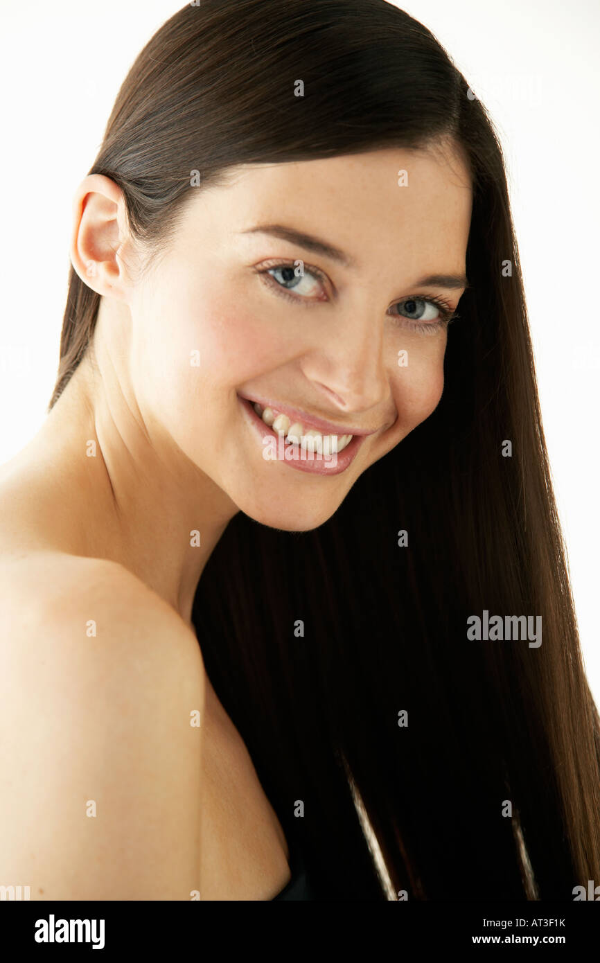 A young woman with long brunette hair smiling to camera Stock Photo - Alamy