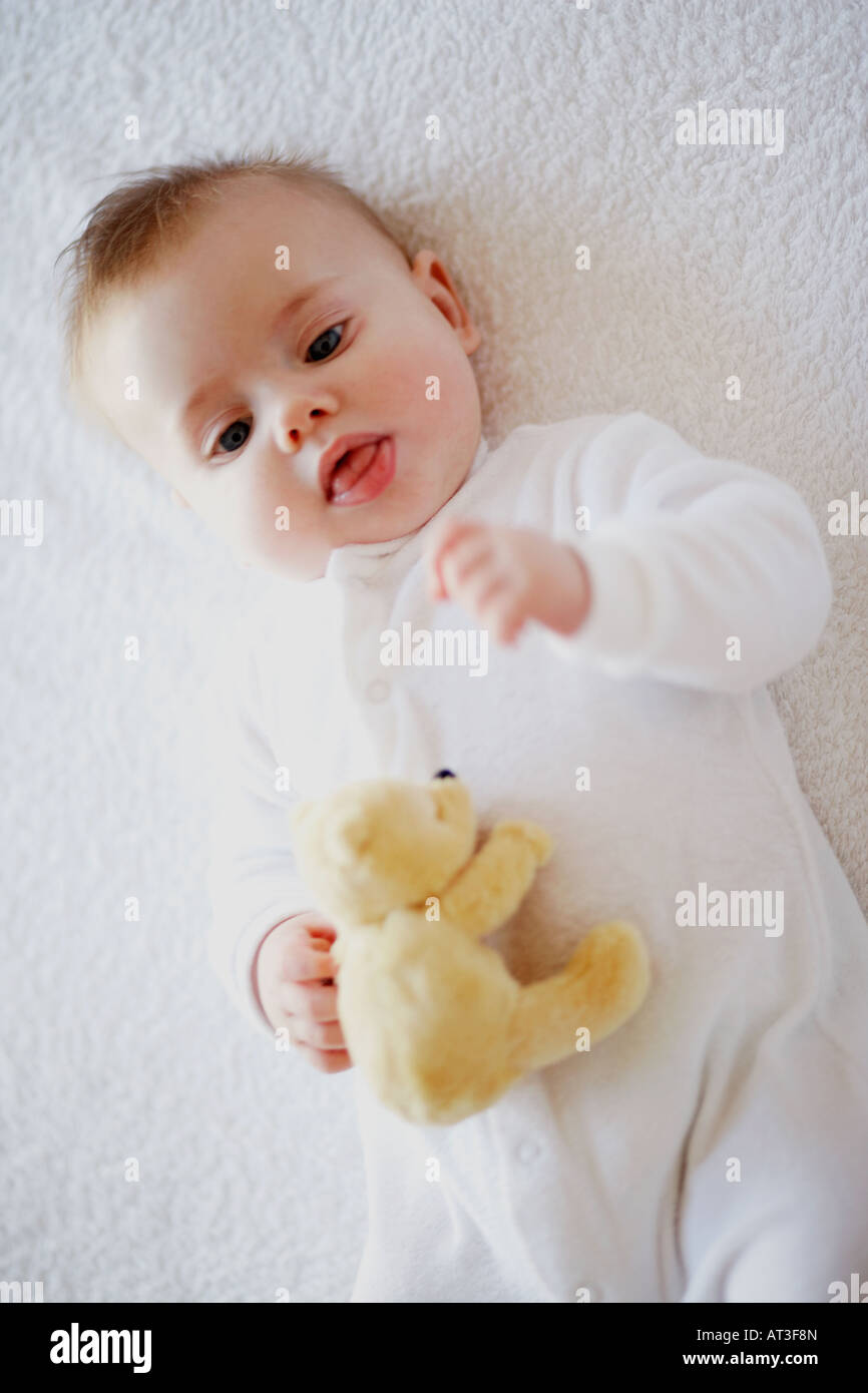 A baby holding a teddy bear Stock Photo - Alamy