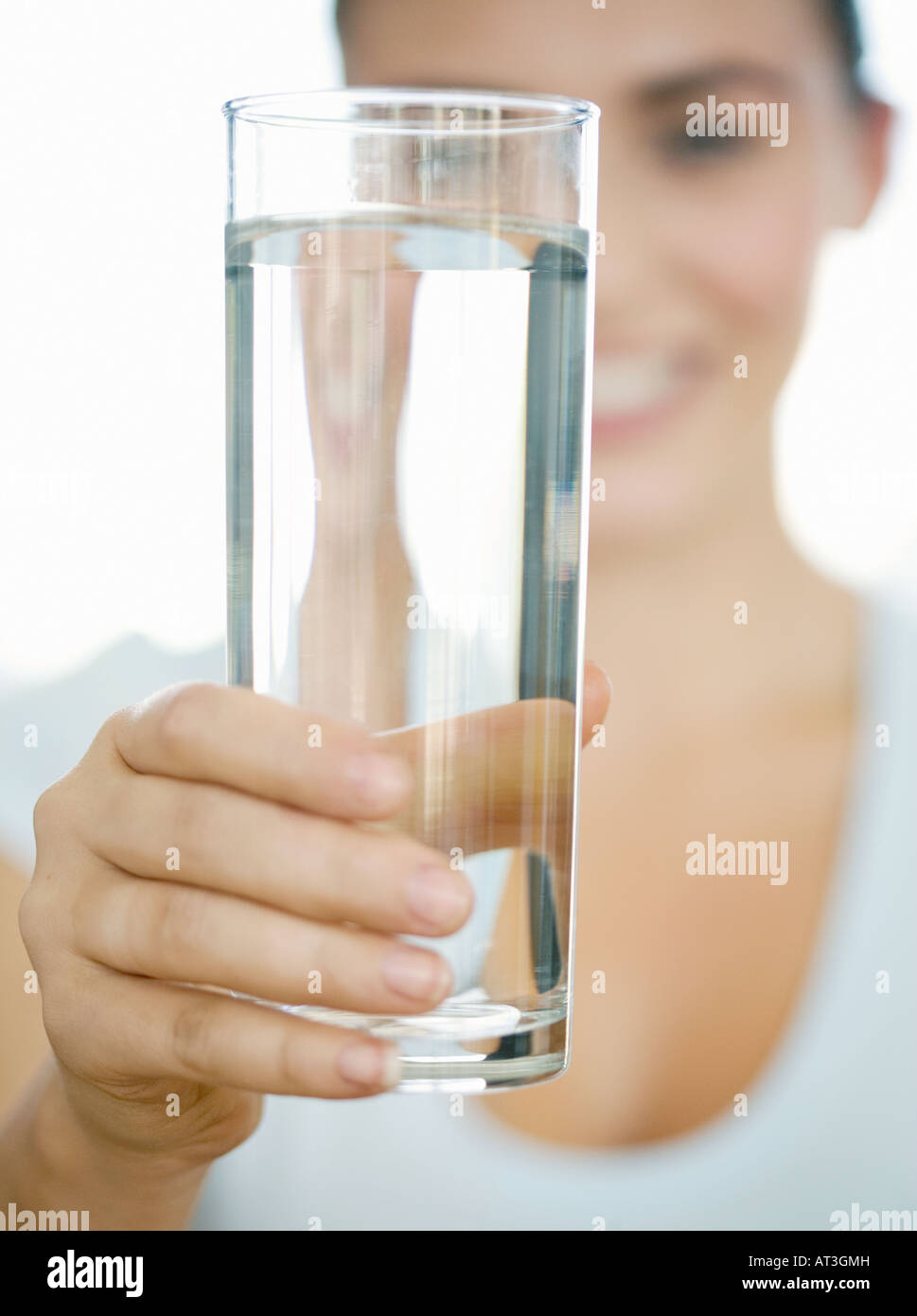 Woman holding a glass of water to camera Stock Photo - Alamy