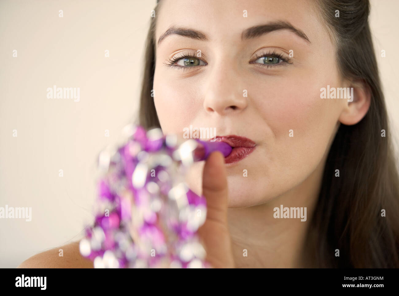 Young woman blowing a party blower Stock Photo - Alamy