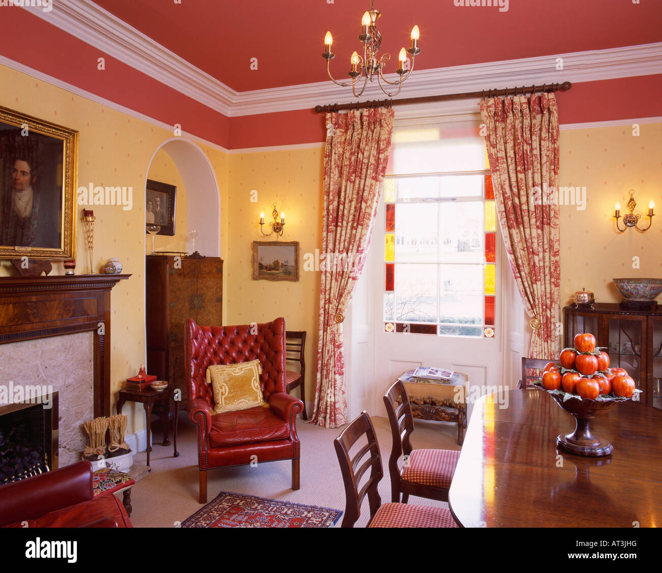 Red Leather Armchair In Yellow Diningroom With Red Ceiling And