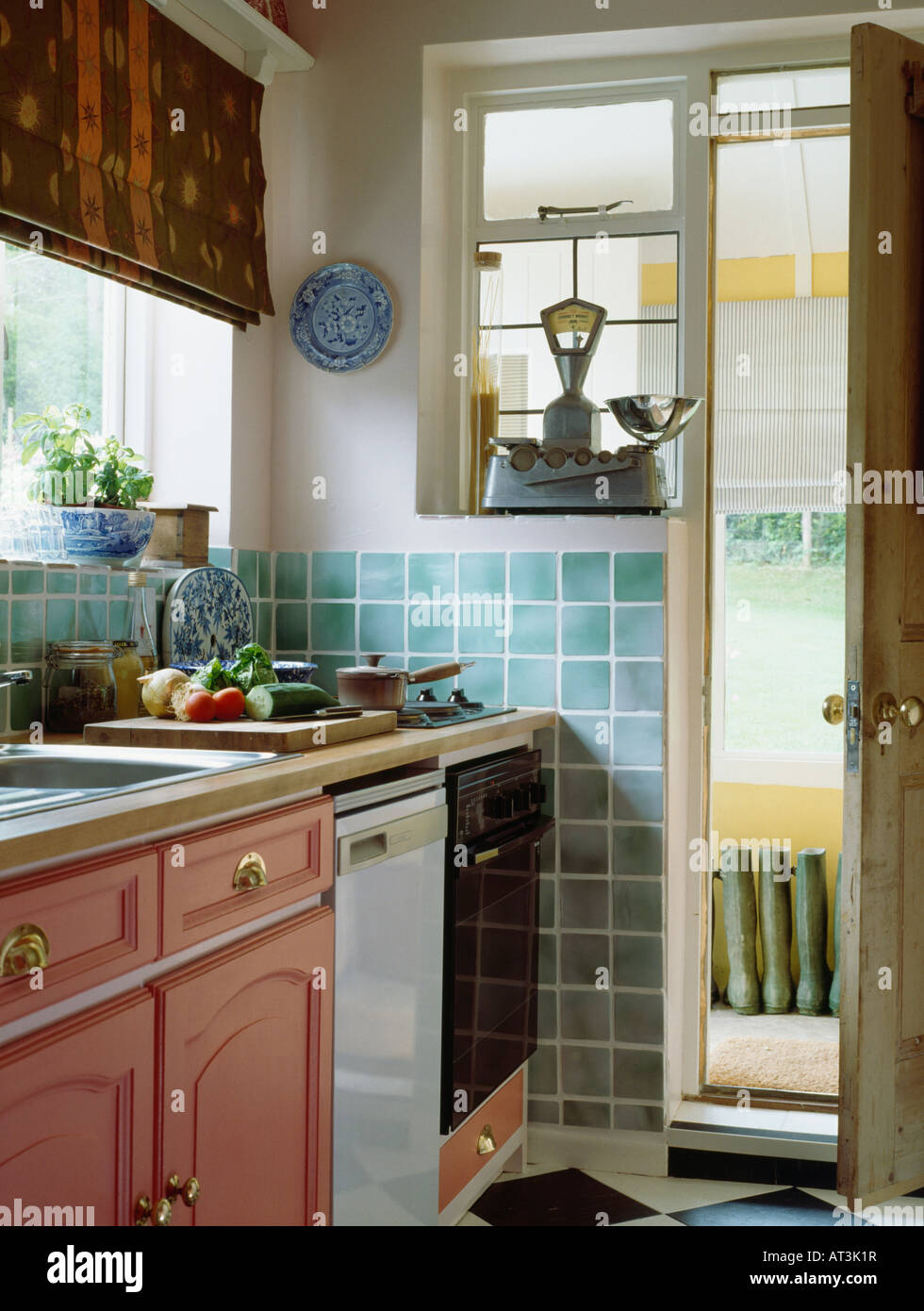https://c8.alamy.com/comp/AT3K1R/scales-on-windowsill-beside-open-door-in-small-nineties-kitchen-with-AT3K1R.jpg