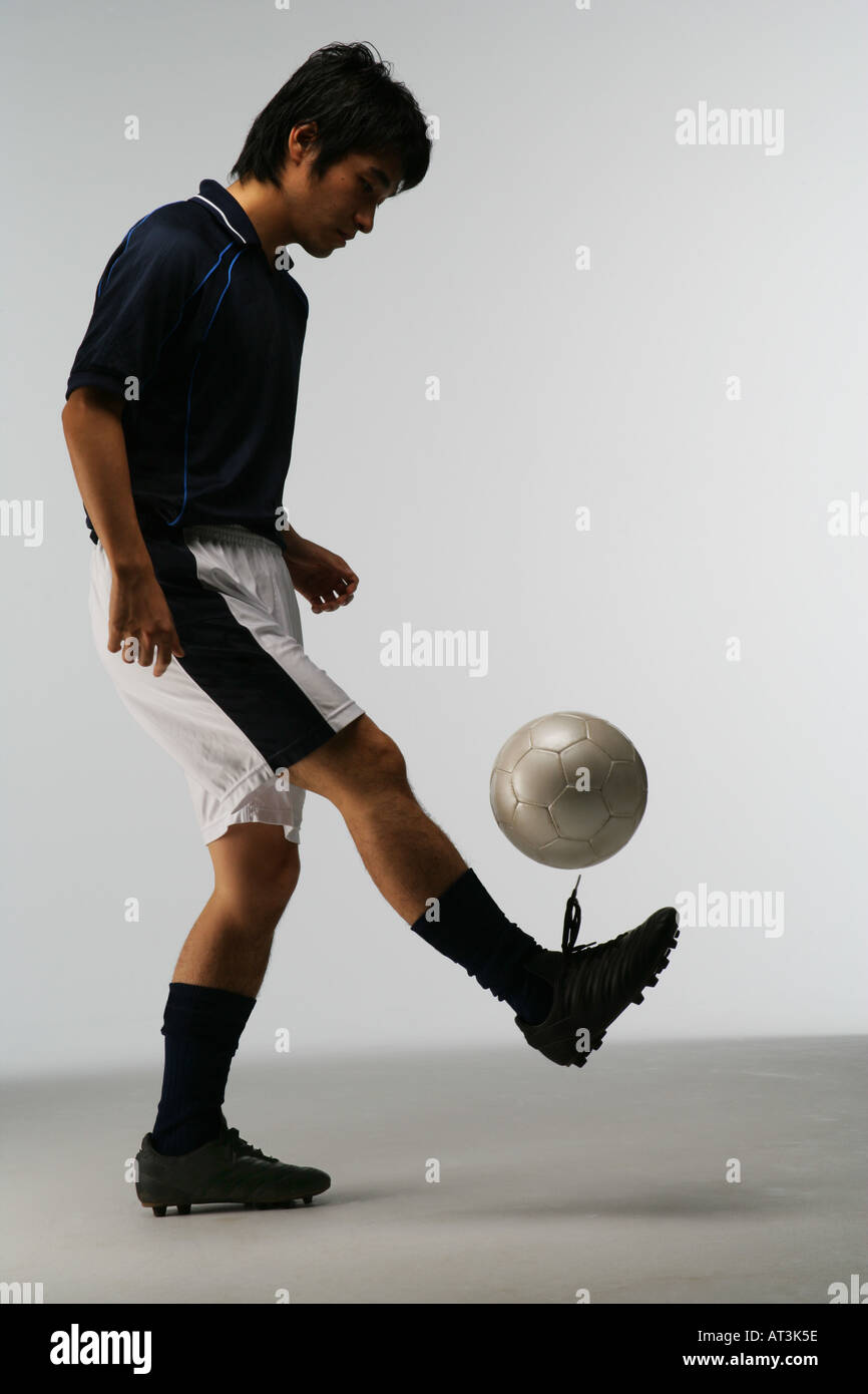 Soccer player juggling ball Stock Photo