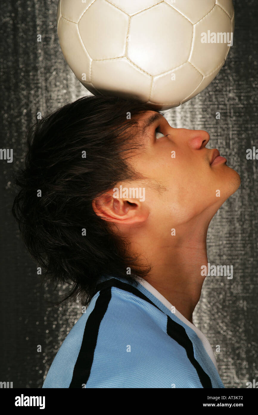 Soccer player balancing ball on head Stock Photo Alamy