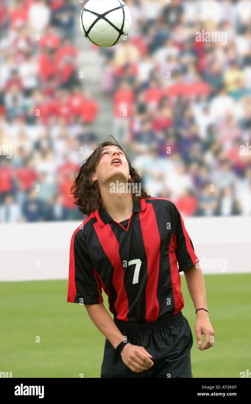 Soccer player juggling ball on head Stock Photo Alamy