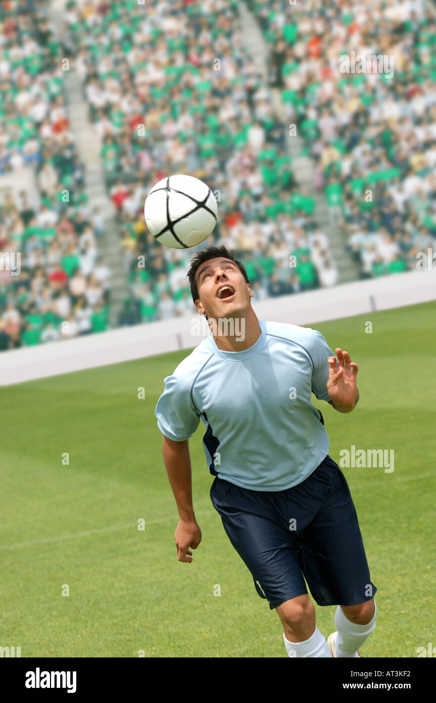 Soccer player juggling ball on head Stock Photo Alamy