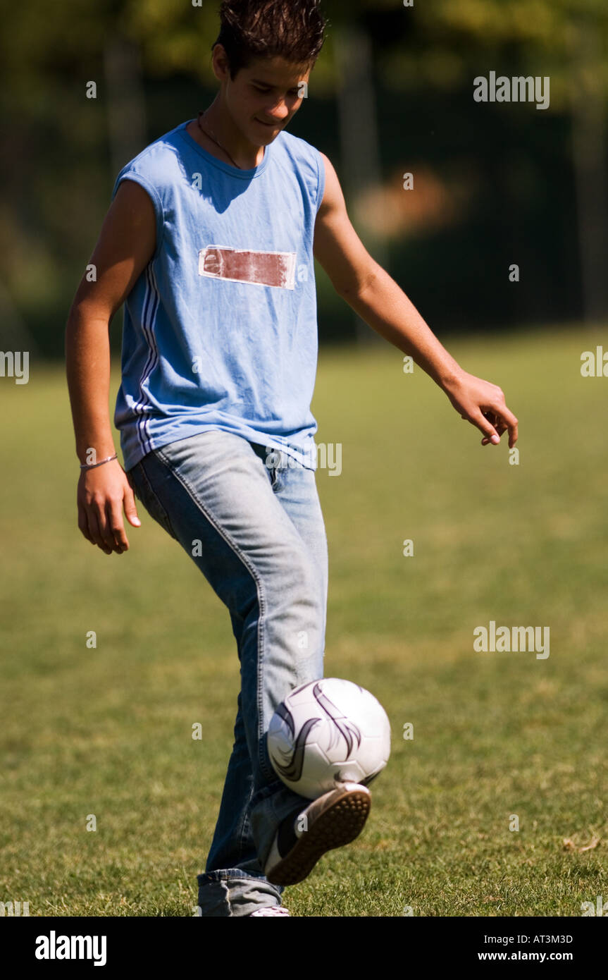 Teenage boy juggling soccer ball Stock Photo Alamy