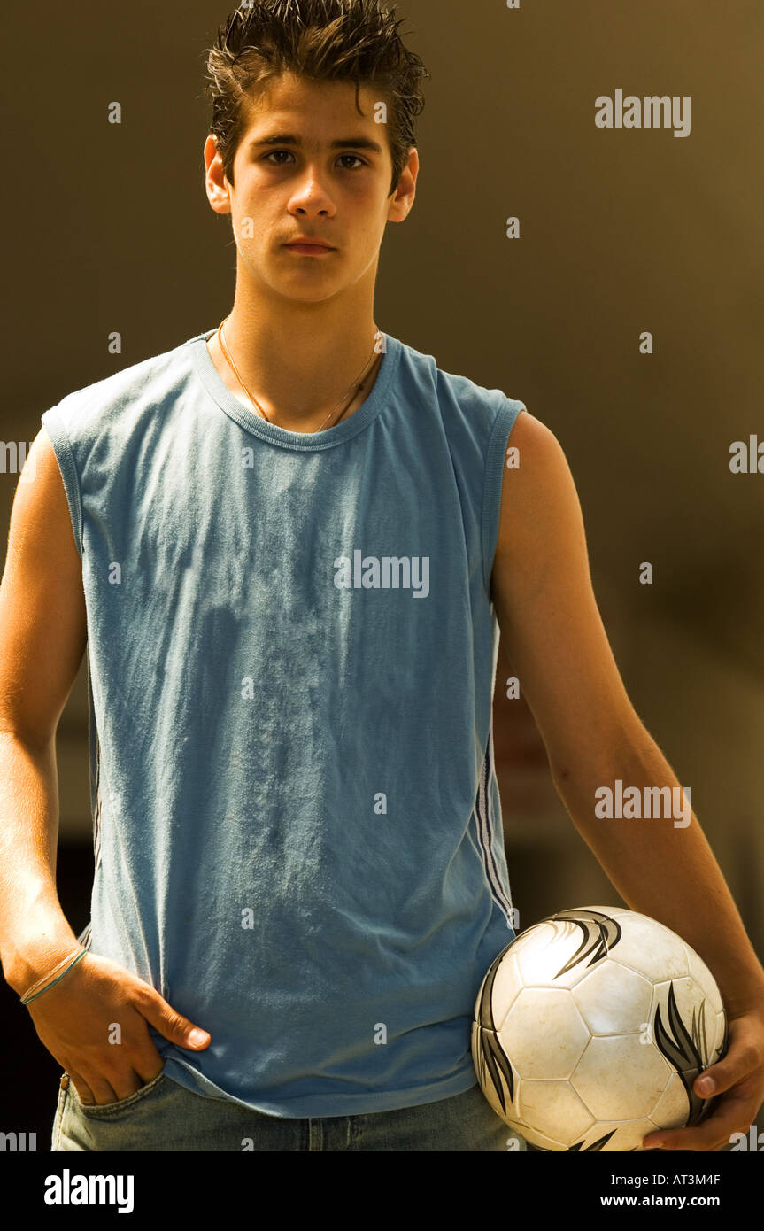 Portrait of teenage boy with soccer ball Stock Photo