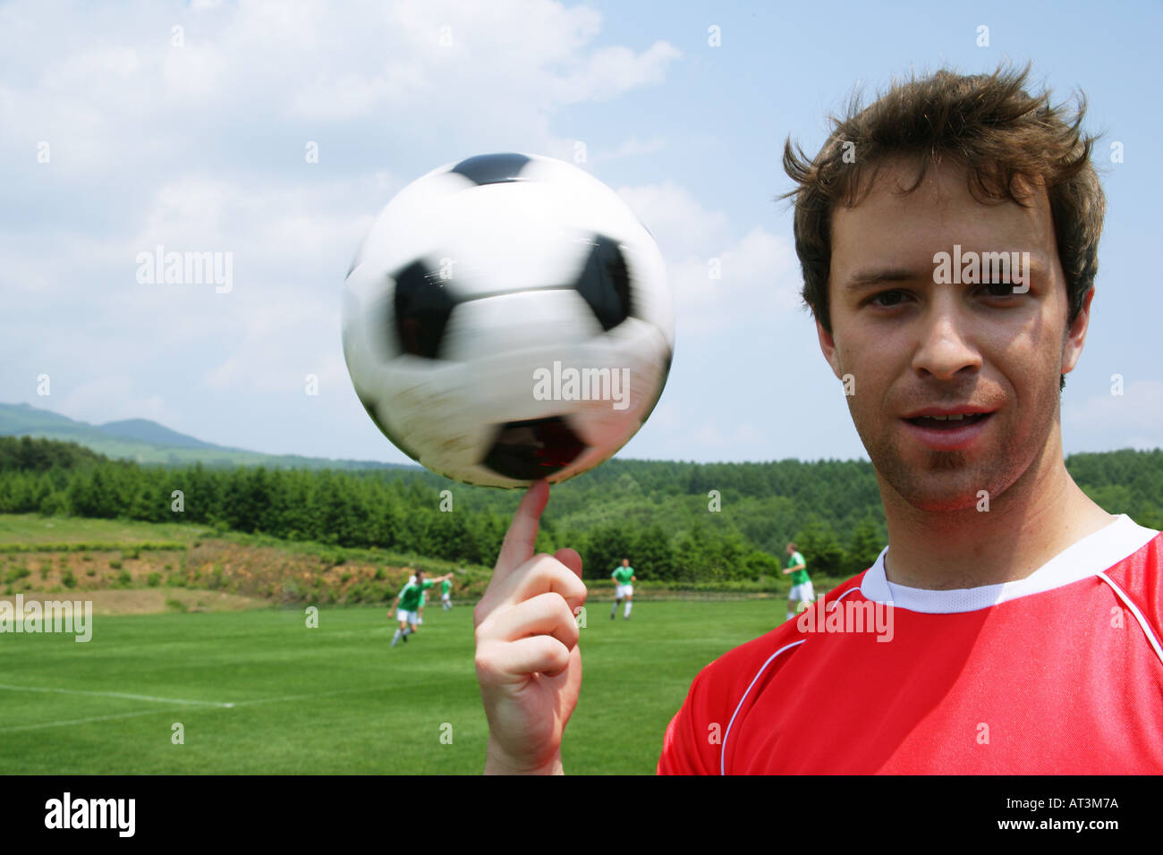 Soccer player spinning ball on finger Stock Photo Alamy