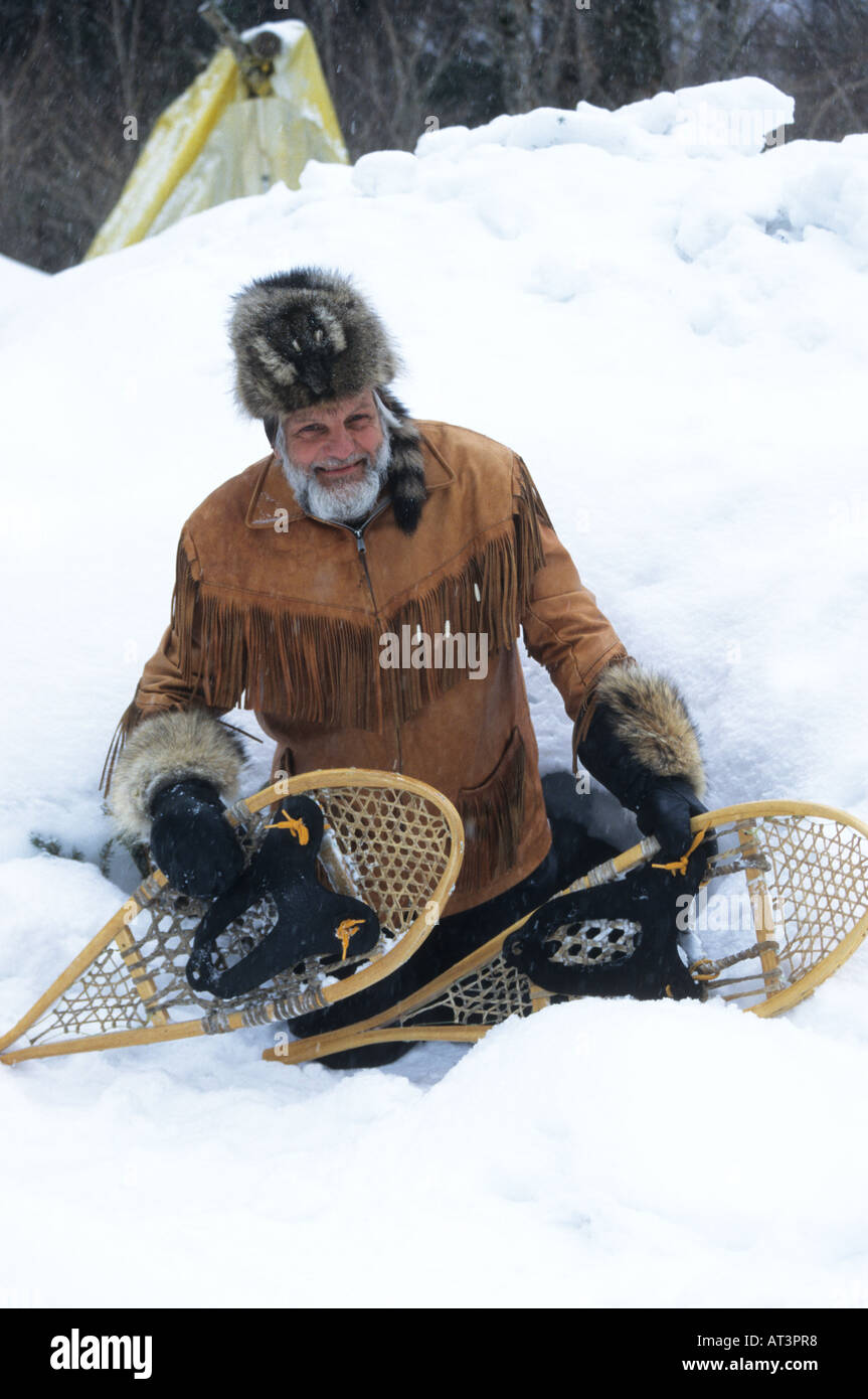 Backwoods guide with his snow shoes buckskin jacket and fur hat. Quebec Canada. Stock Photo