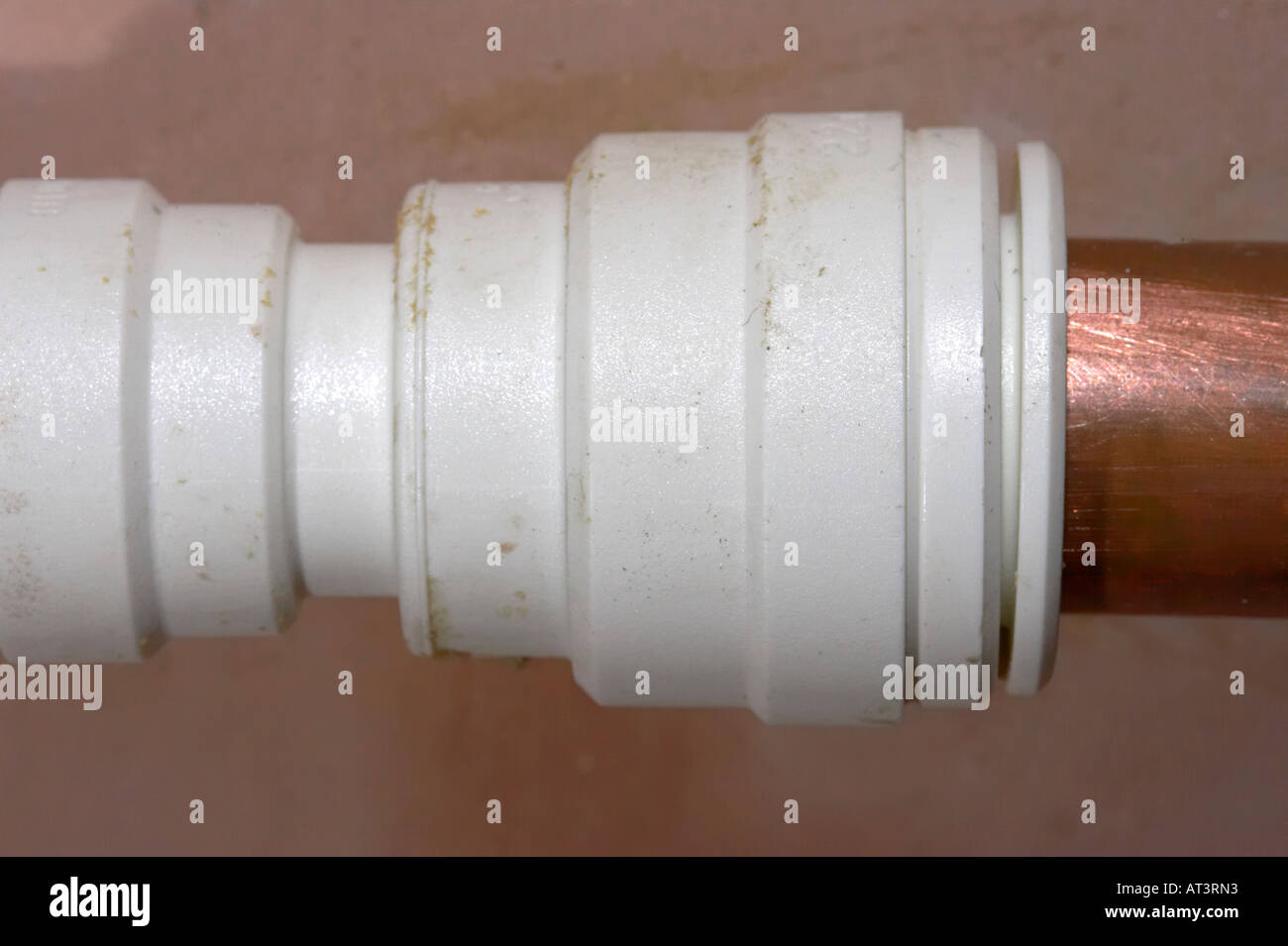 modern speedfit push fit plastic pipe fitting attached to old style copper  pipe in bathroom Stock Photo - Alamy