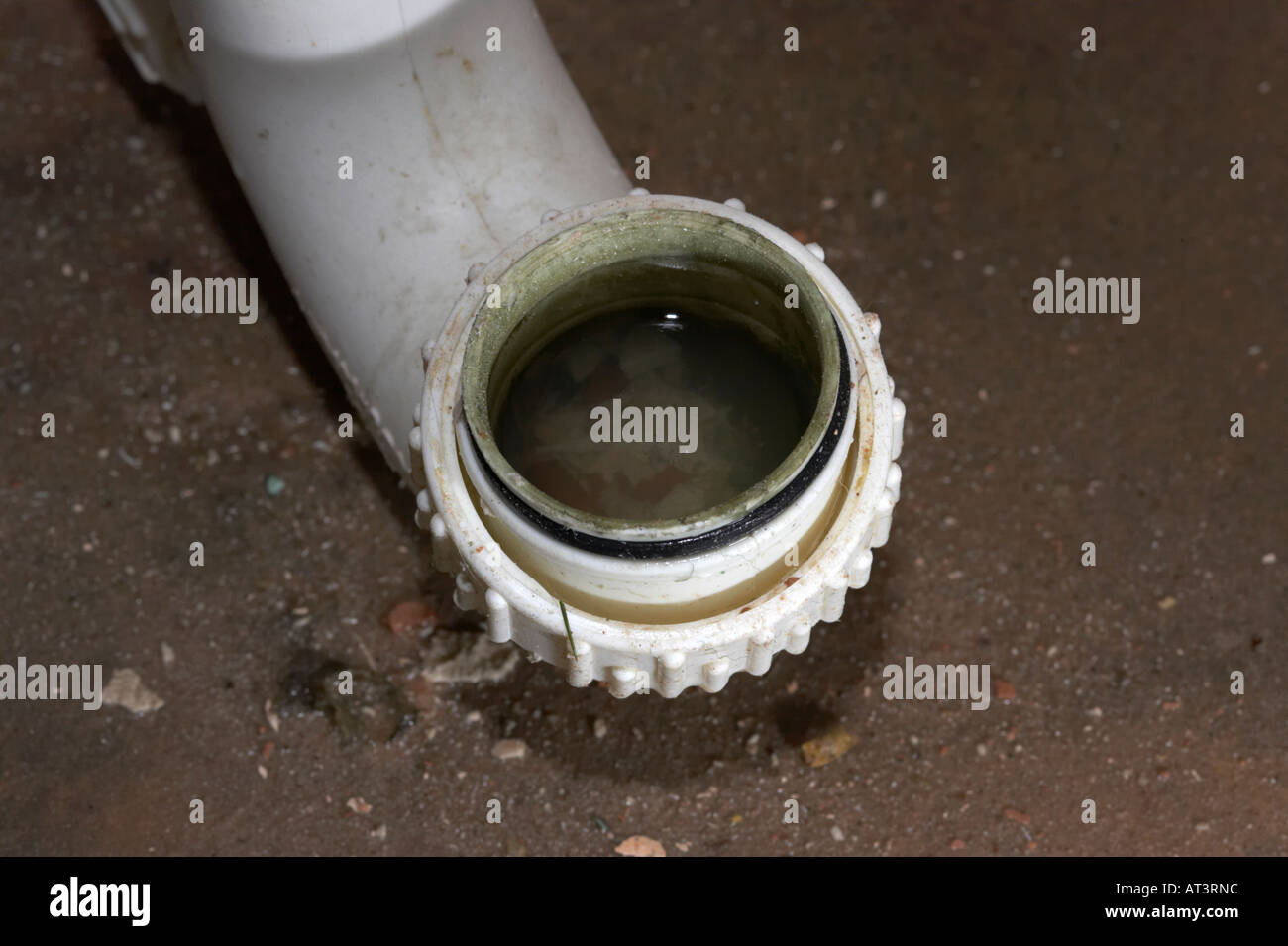 old dirty unsanitary plastic sink waste pipe with connector on stripped