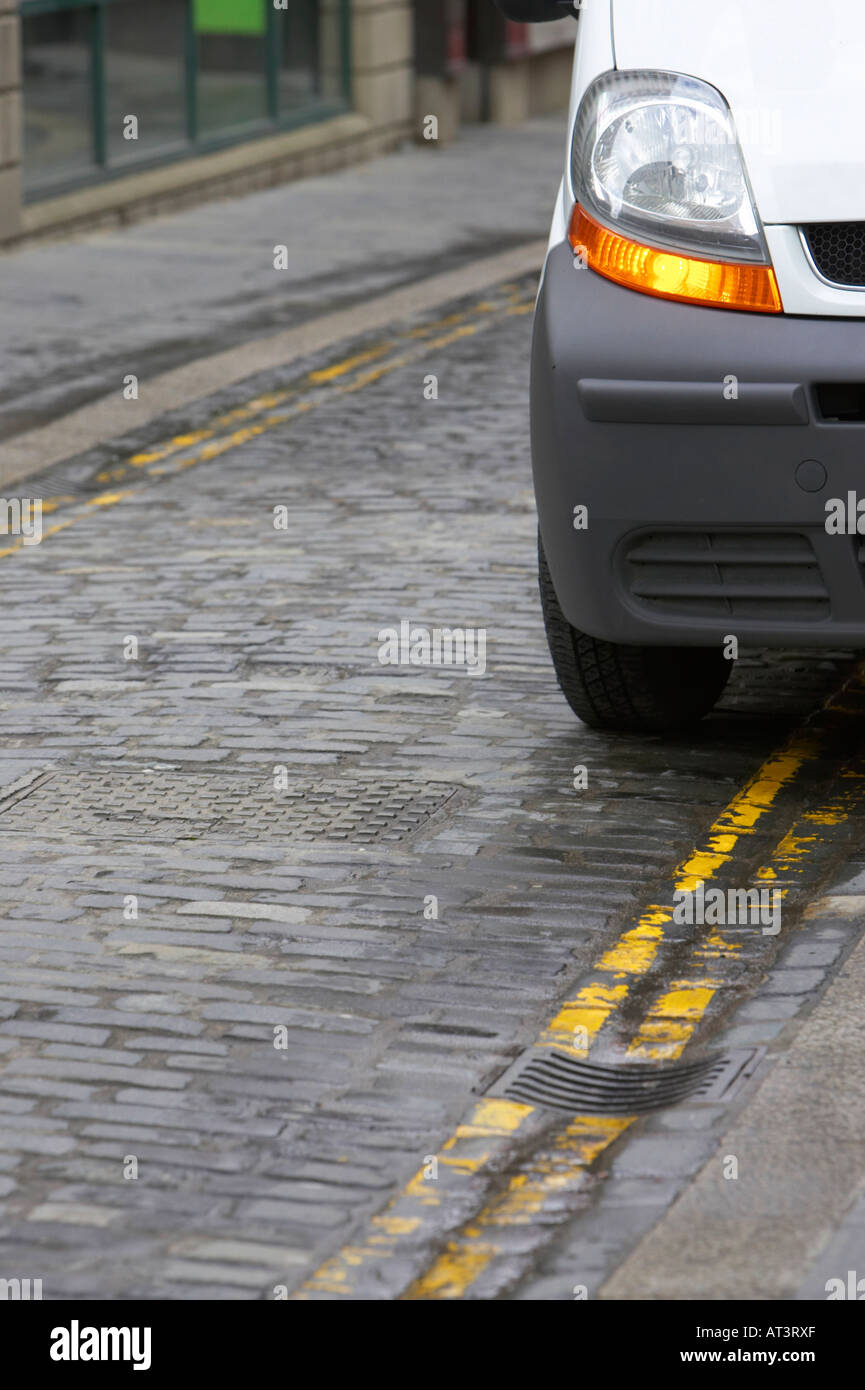 front of white van with hazard warning lights showing parked over