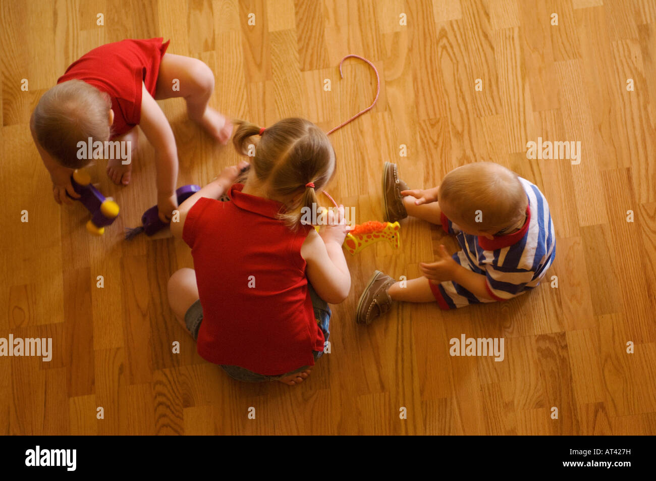 Children on floor playing hi-res stock photography and images - Alamy