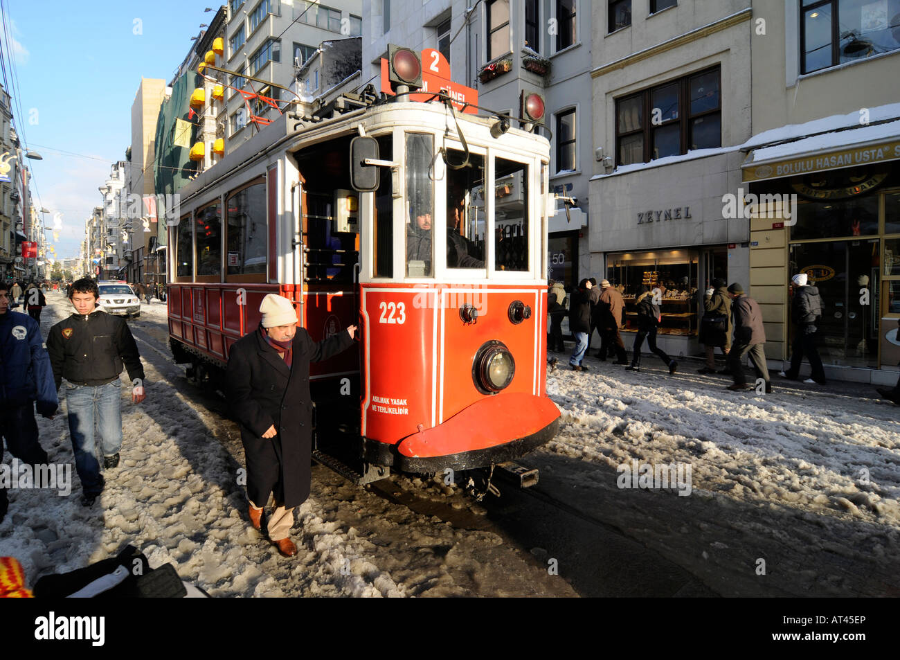An old man exiting the 'nostalgy' tram running between Taksim Square and Tunel on Istiklal Cadesi, in Istanbul, Turkey Stock Photo