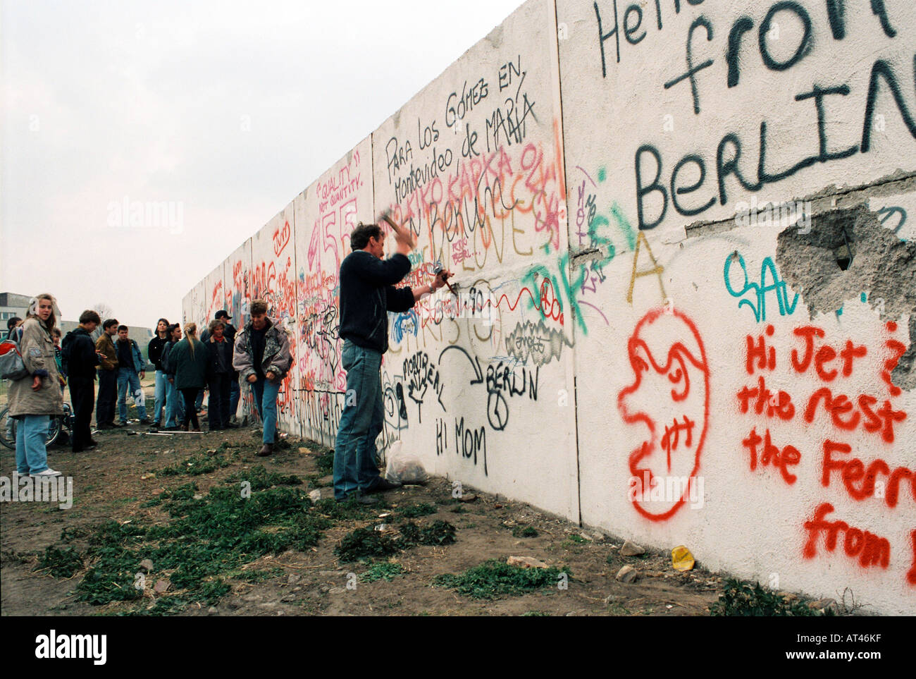 The Fall of the Berlin wall, 1989. A souvineer hunter cuts pieces of the wall. Stock Photo