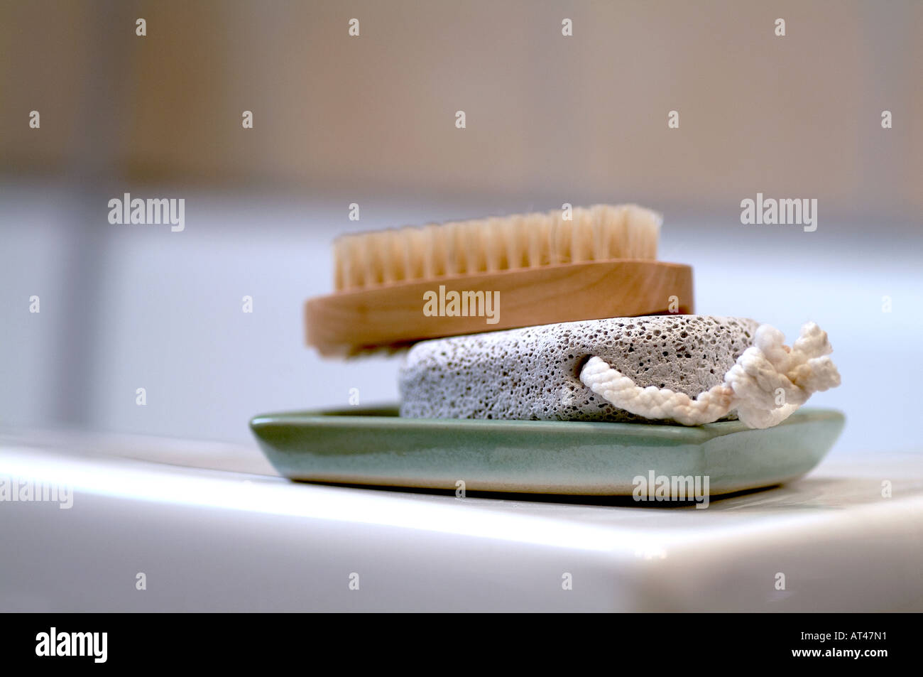 Nail brush, pumice stone and soap on tray on bathtub Stock Photo Alamy