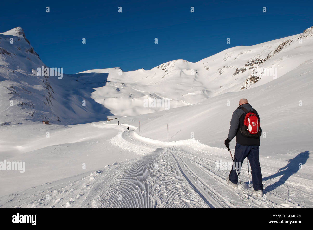 Winter walker close to Buschalpsee on the path from  Grindelwald First with the Faulhorn mountain facing Stock Photo