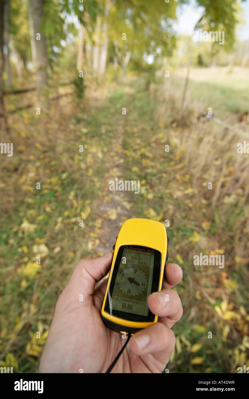 An yellow GPS receiver in a left male hand Stockholms Lan Sweden September 2007 Stock Photo
