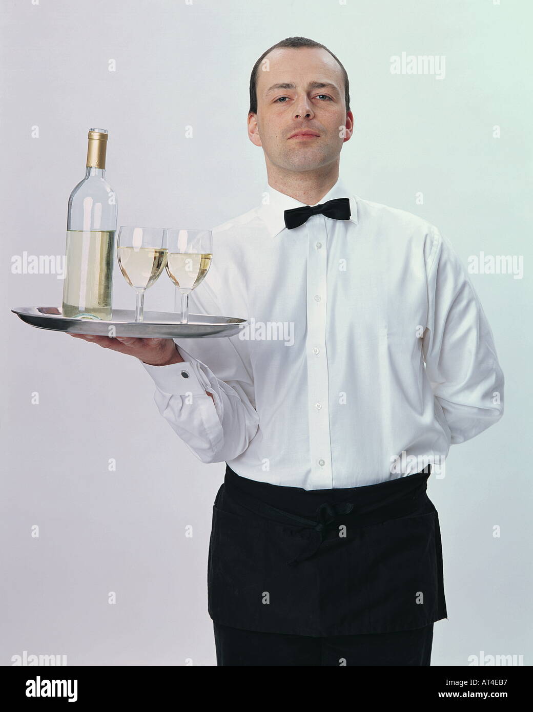 Waiter serving white wine Stock Photo