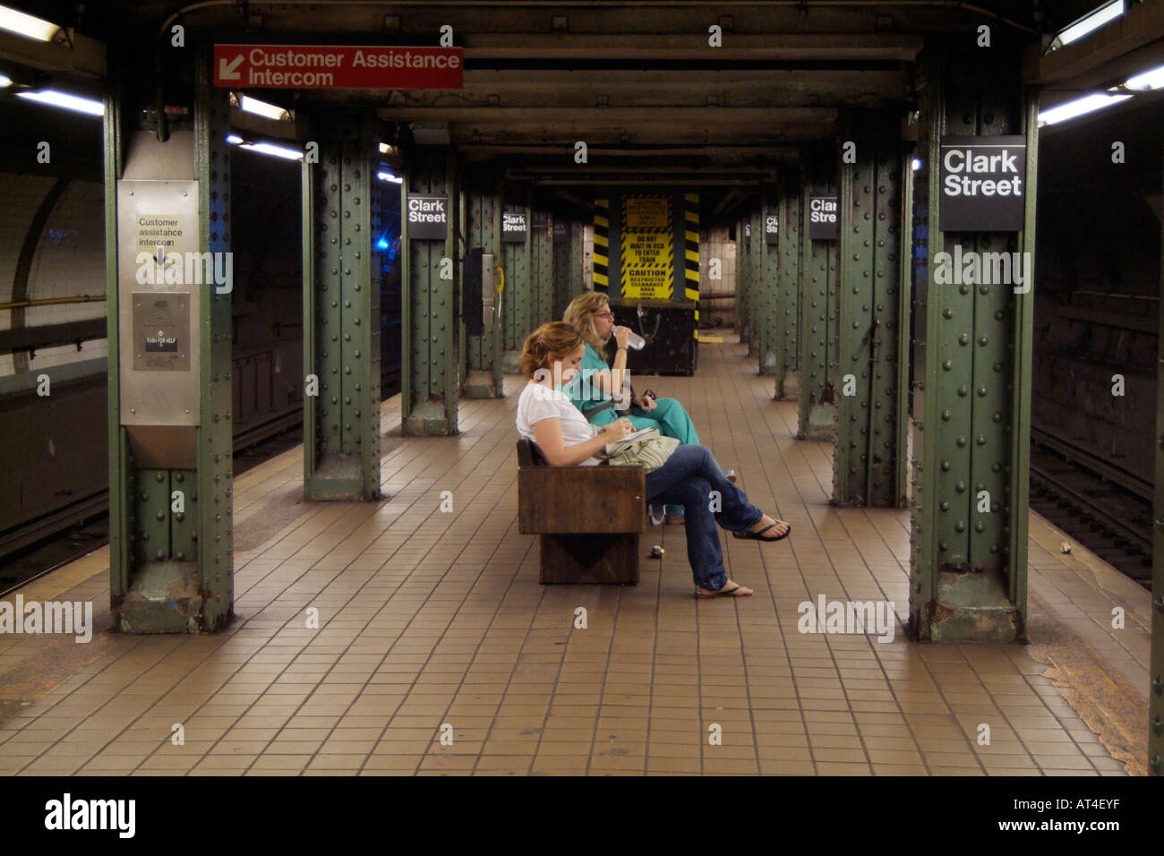 Clark Street subway station Brooklyn New York USA. Women wait for train