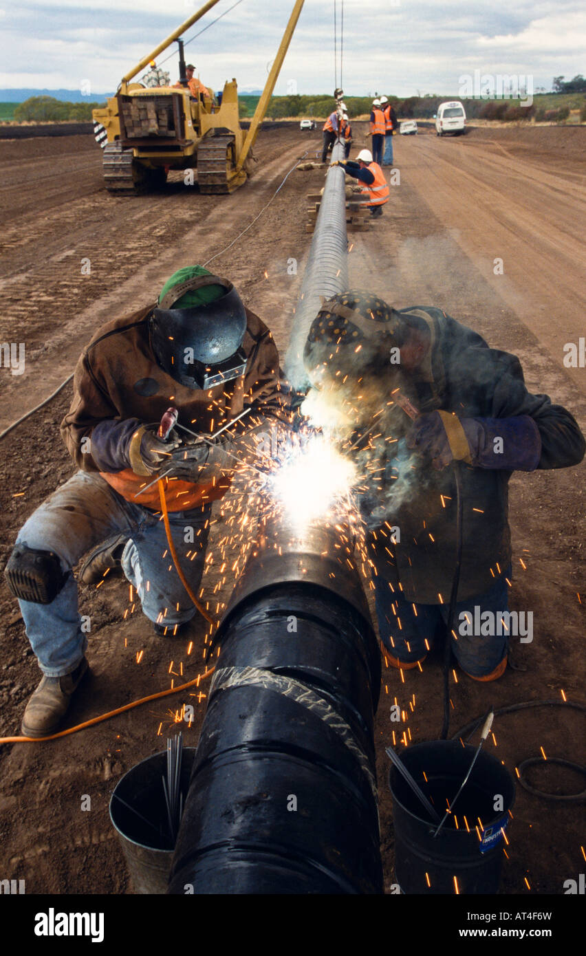 Welders joining pipe Stock Photo