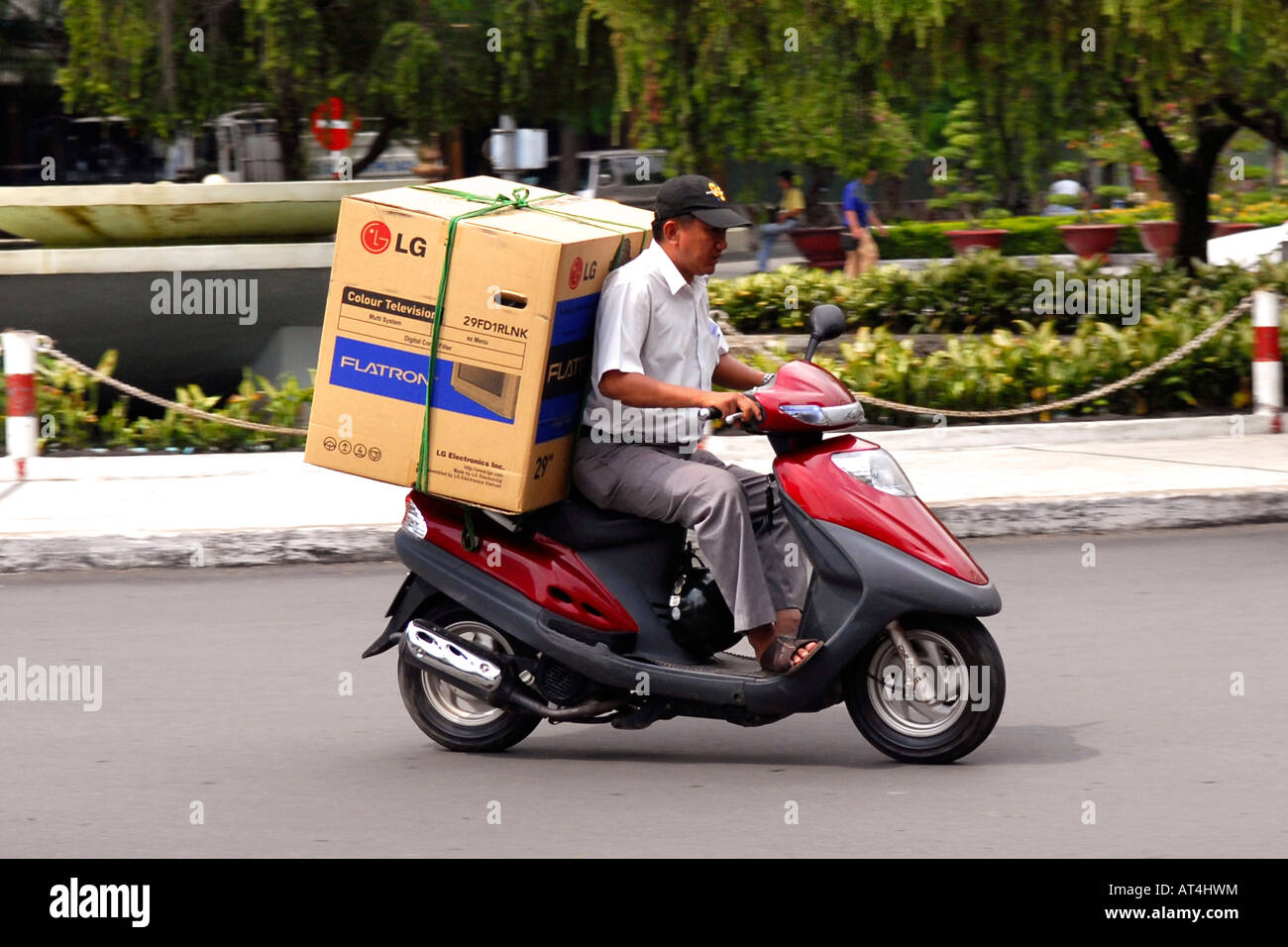 Asia Far East Vietnam Saigon typical street scene of man transporting new  big screen colour tv on motor bike in motion Stock Photo - Alamy