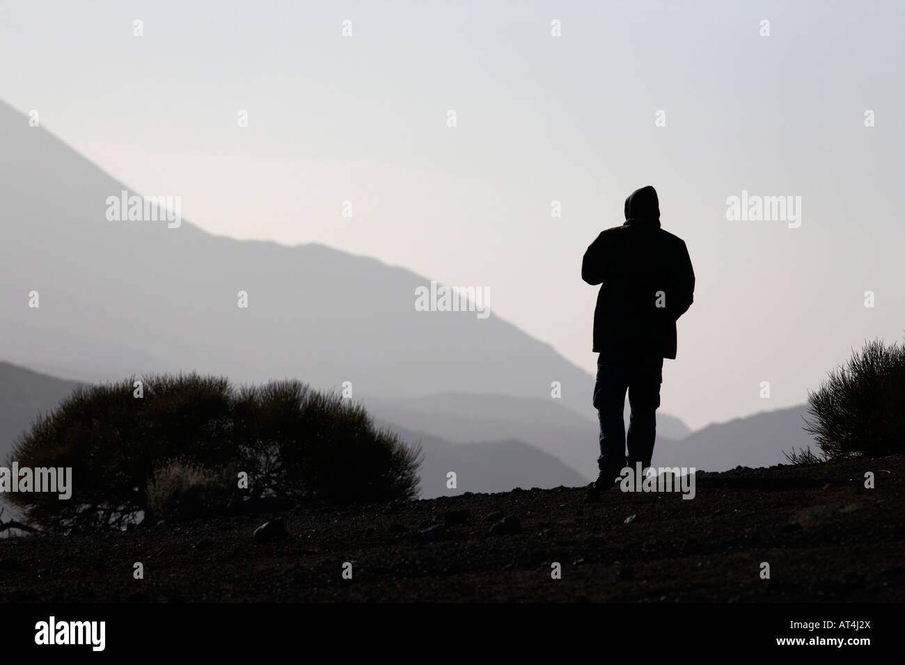 man standing alone in desert on mountainside in tenerife canary islands spain Stock Photo