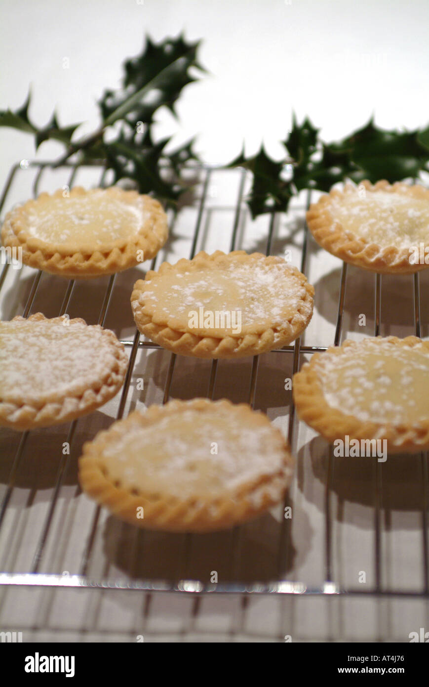 Mince Pies Sprinkled With Icing Sugar on Wire Rack With Sprigs of Holly ...