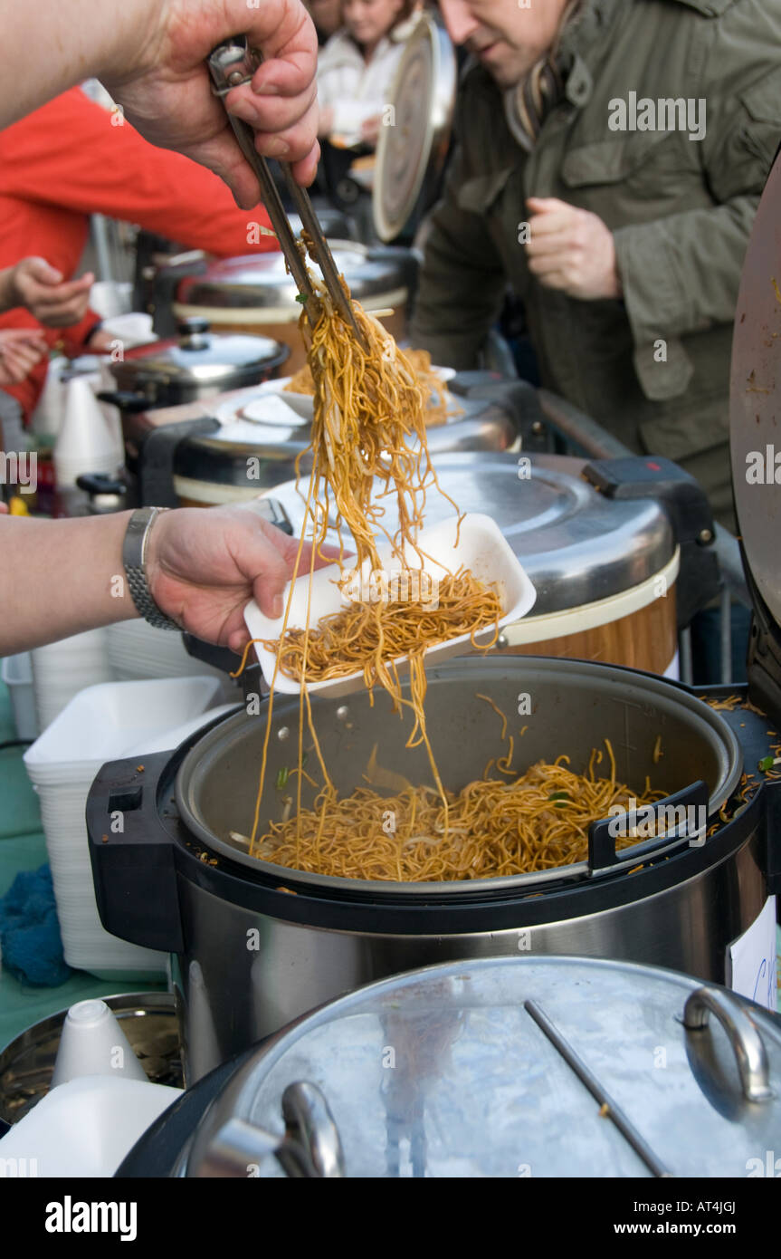 serving hot noodles at a street cafe during Chinese new year