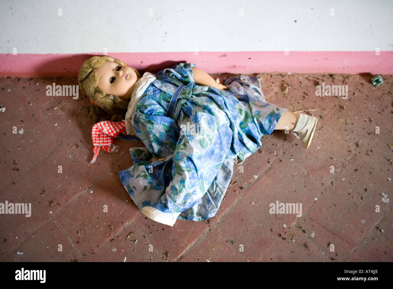 Childs doll abandoned in ruined house Stock Photo